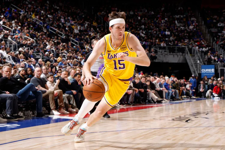 Austin Reaves handling the ball in a Lakers home jersey during the 116-99 win over Brooklyn Nets.