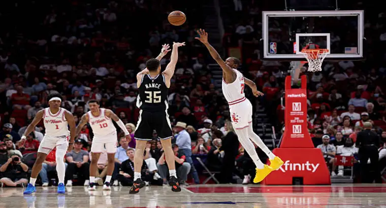 Pete Nance of the Milwaukee Bucks attempts a jump shot over Kevin Durant of the Houston Rockets during their April 1, 2026, matchup at Toyota Center.