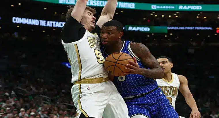 Orlando Magic player drives hard to the basket past Boston Celtics center Luka Garza during the April 12 2026 NBA regular season game at TD Garden