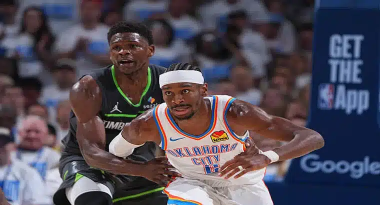 An Oklahoma City Thunder player in white drives the ball against a Minnesota Timberwolves defender in a dark jersey during an NBA game