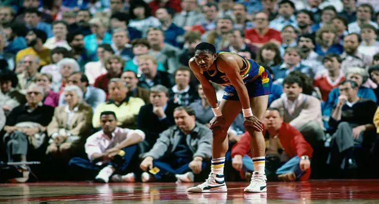 Denver Nuggets legend Alex English in vintage rainbow jersey during a January 1986 NBA game representing the early era of the Clippers vs Nuggets rivalry
