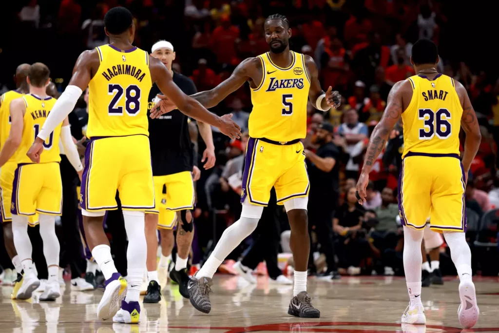 Lakers players Rui Hachimura (#28) and Marcus Smart (#36) high-fiving during the Rockets vs Lakers 2026 NBA playoff game