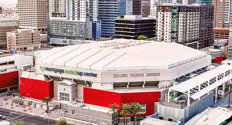 Aerial view of Mortgage Matchup Center arena surrounded by downtown Phoenix skyline and city streets