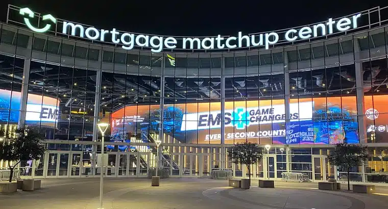 Mortgage Matchup Center exterior at night with illuminated arena signage and LED displays in downtown Phoenix AZ
