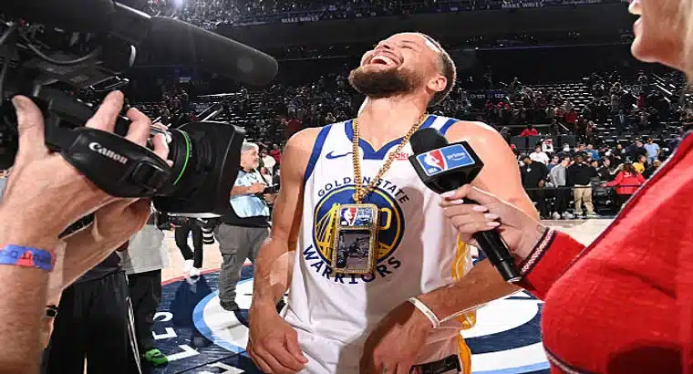 Stephen Curry laughing and wearing a gold chain during his post-game interview after the Golden State Warriors' 126–121 Play-In win over the LA Clippers on April 15, 2026